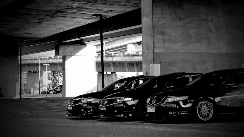 A row of parked cars in front of a building